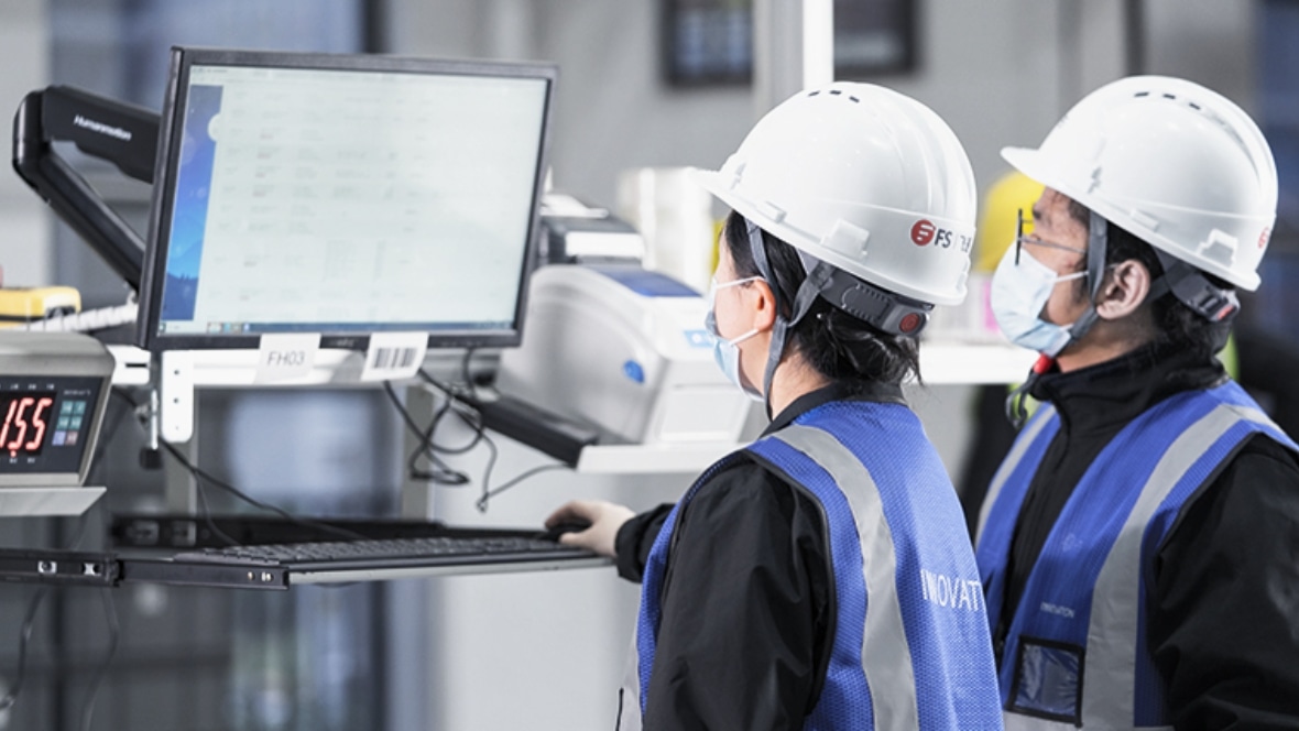 The image shows  customer order fulfilment warehouse distribution to supply chain solution and a staff member is scanning the box with a tool to prepare the goods for delivery.
